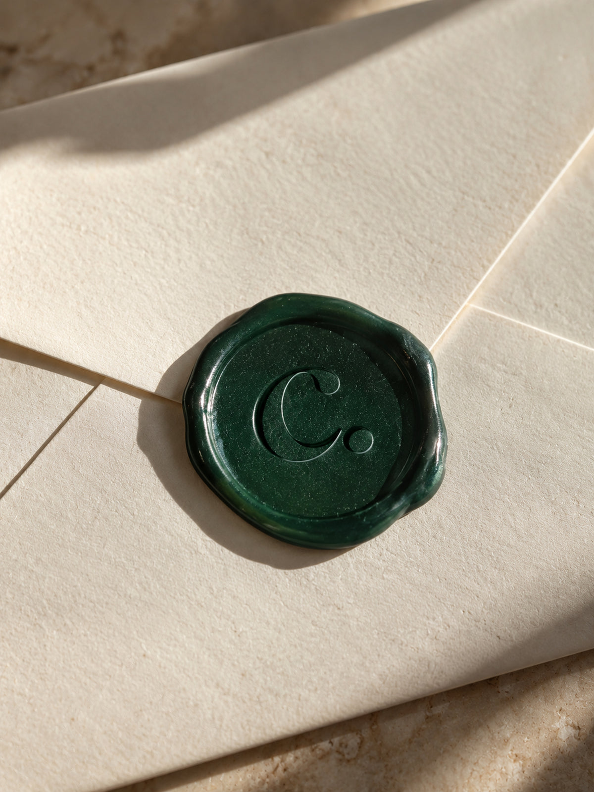 Cream envelope sealed with green wax stamped with a c., the signature seal of The Culture Society Edit.